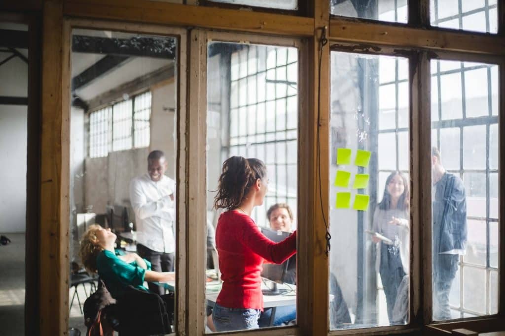 REFLECTION OF PEOPLE IN GLASS DOOR