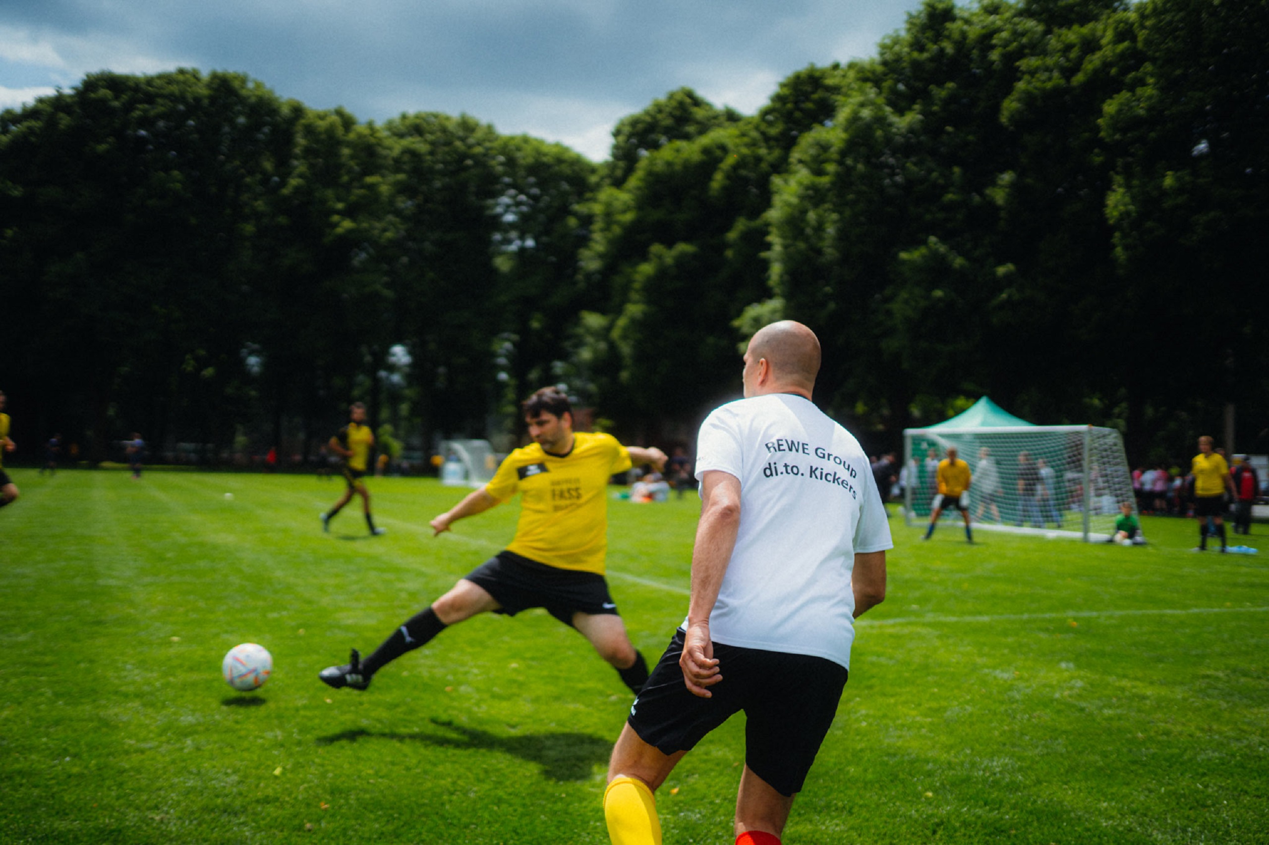 Image of a soccer match with two players standing in front of the goal.