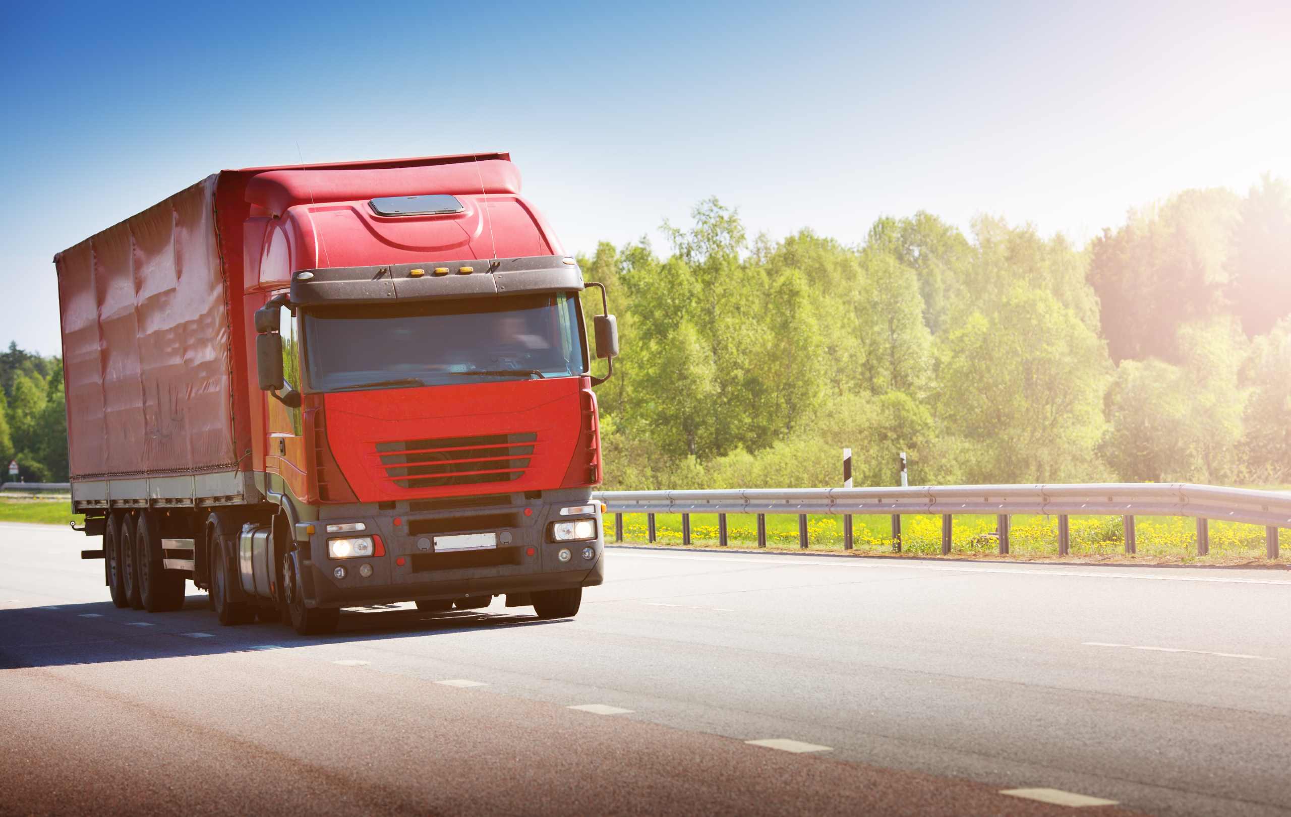 Truck driving on your road in the sun.