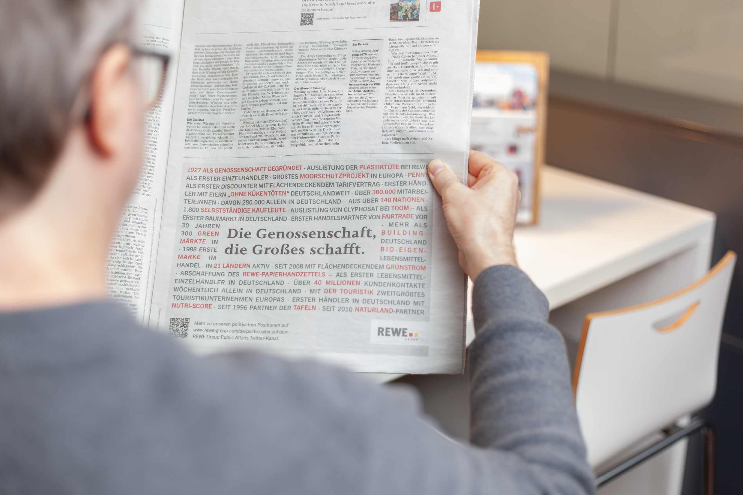 Open newspaper with an article titled 