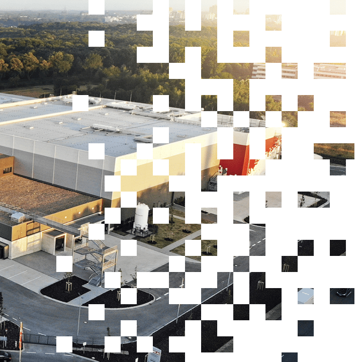 Aerial view of a logistics center surrounded by a wooded area.