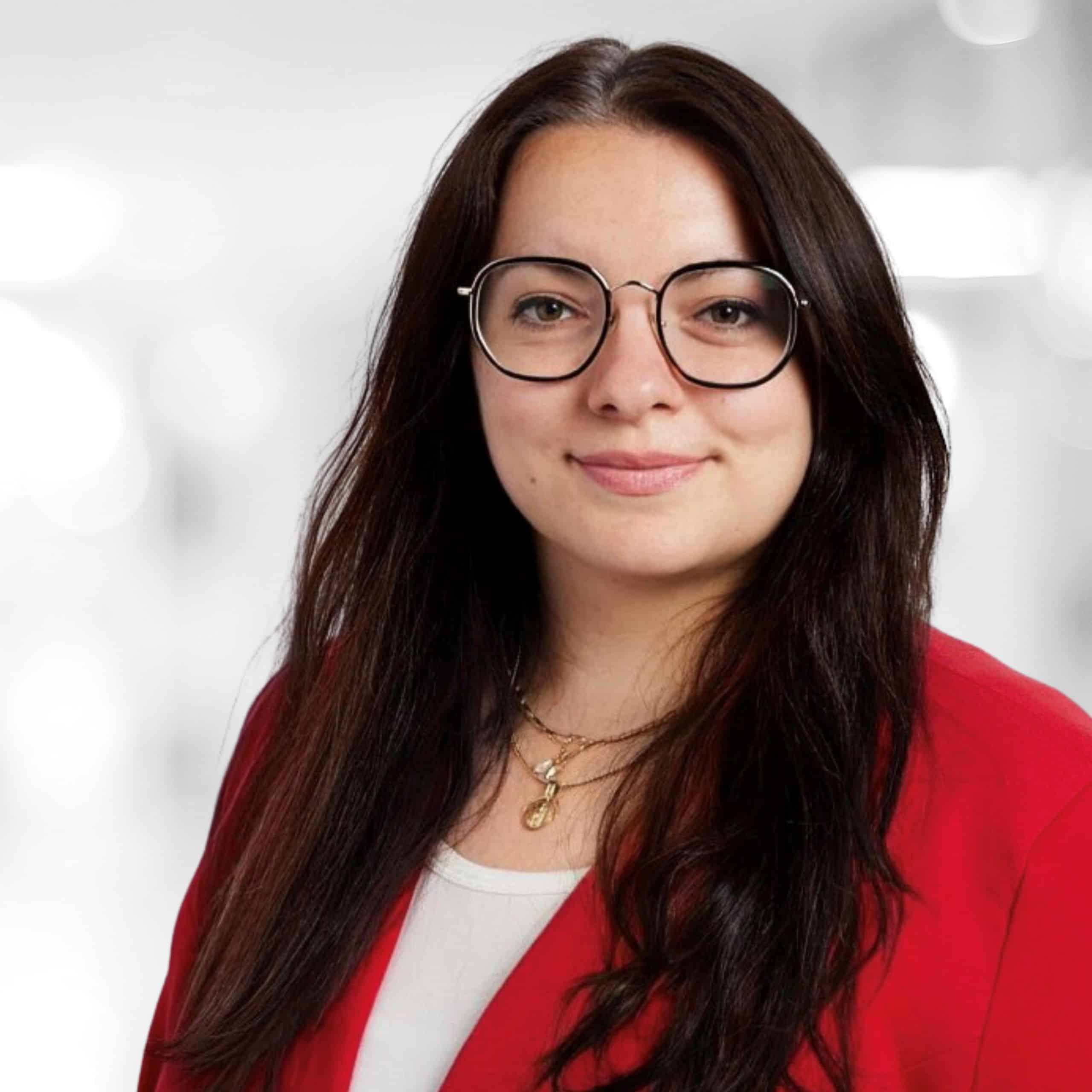 Portrait of Martina Weinhold. She smiles at the camera, the background is blurred.