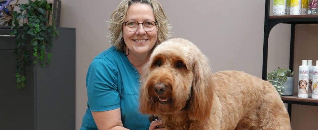 Portrait of Andrea Ozekker with her dog Harry, whom she groomed.