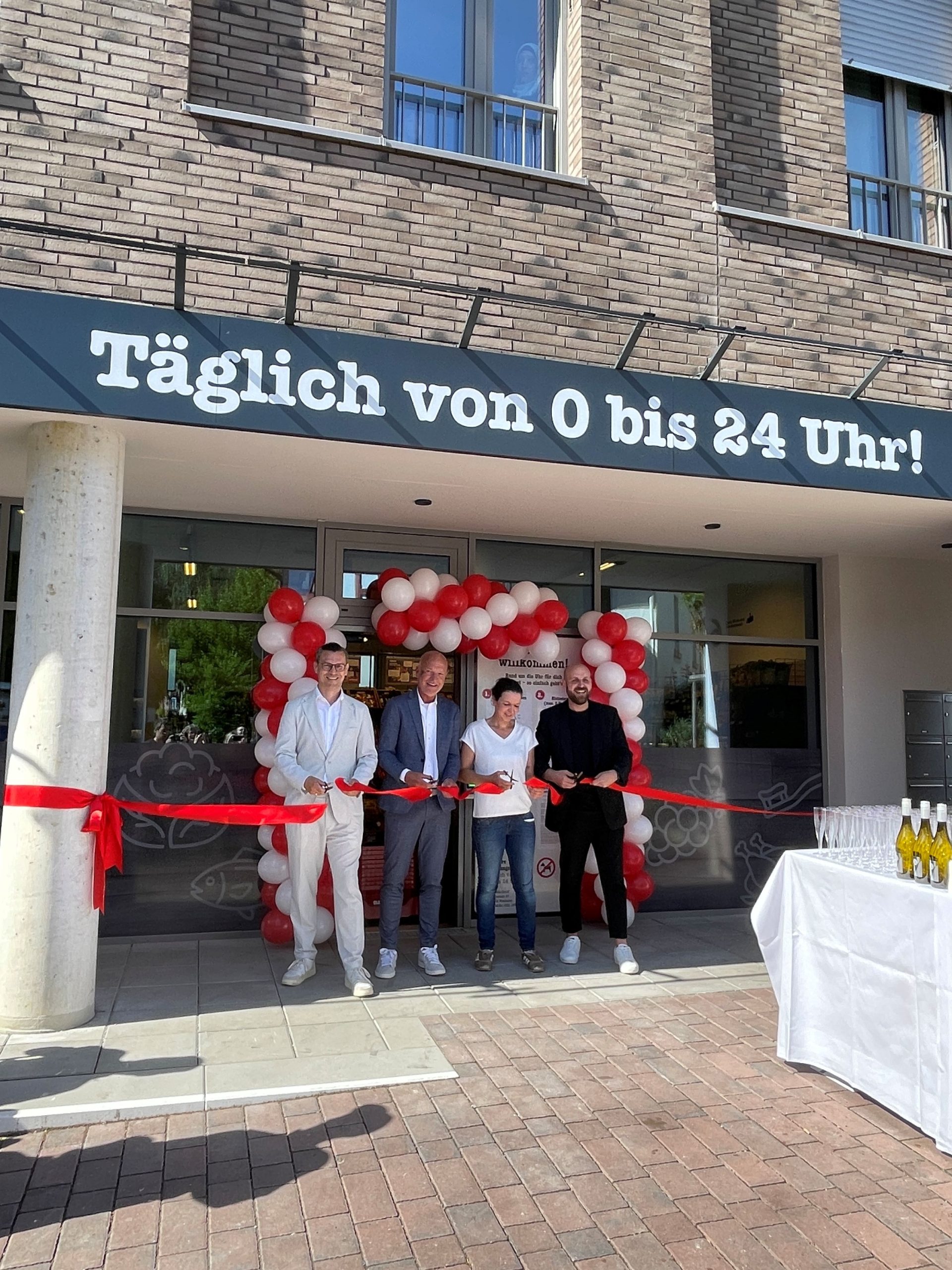 Four people ceremoniously open a 